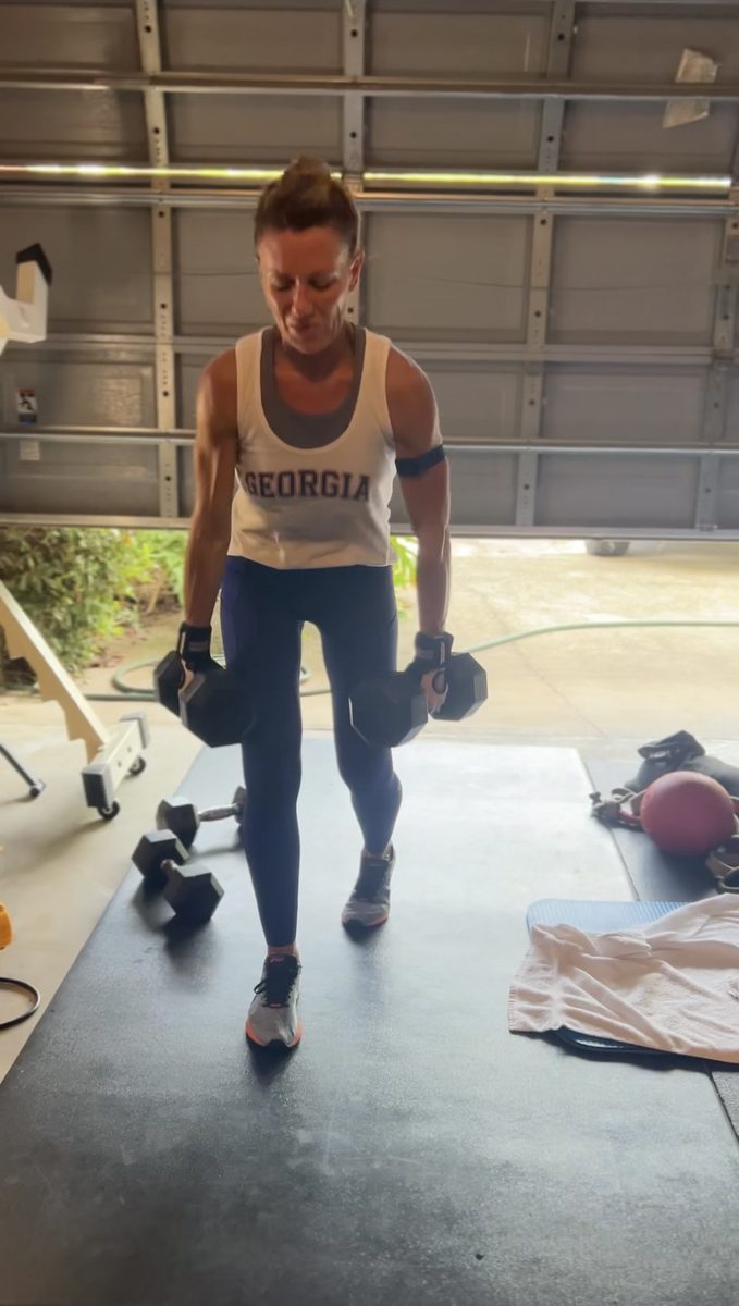 Ashley training with dumbbells in the garage — Real Lyfe Fitness