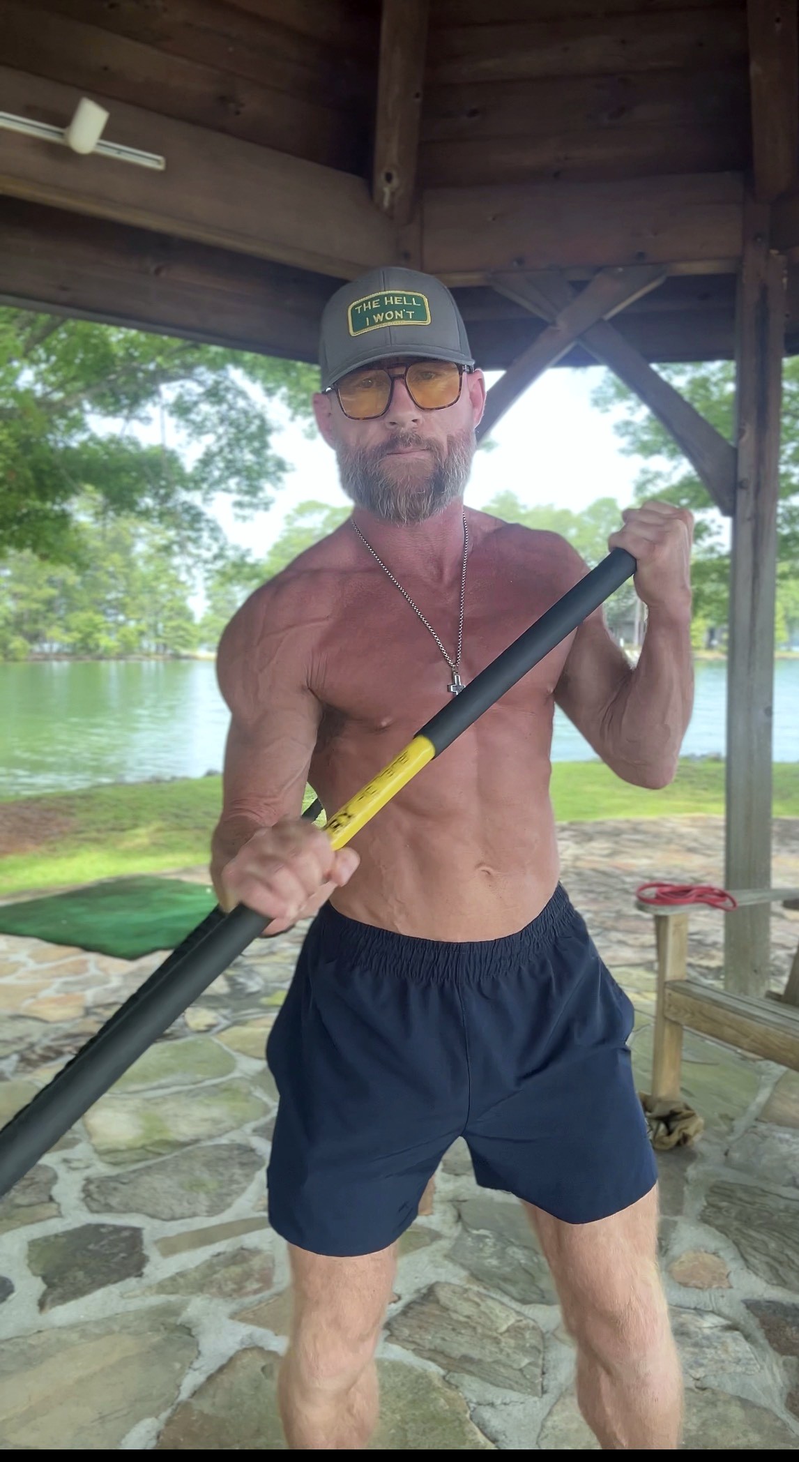 Carl training with a steel mace at the lake — Real Lyfe Fitness